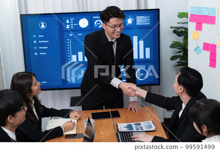 Employees shake hand for symbol of harmony after successful business meeting. 99591499