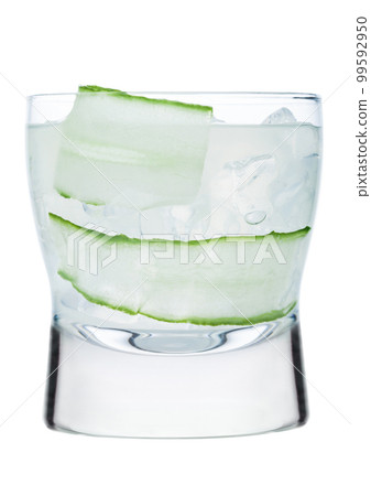 Fresh cold cucumber water with ice cubes and cucumber slices isolated on white background.  99592950