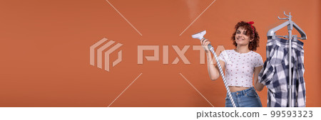 Panoramic frame of young girl. A smile on your face. A steamer for ironing. A girl with curly hair. Panoramic frame of young girl. A smile on your face. A steamer for ironing. A girl with curly hair. 99593323