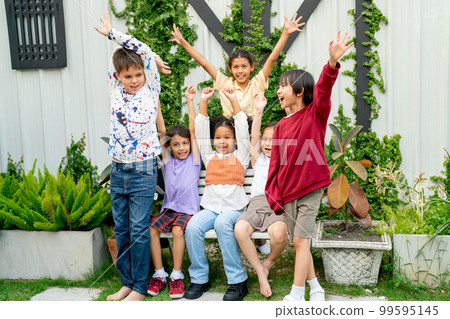 Group of different ethnic including African American and Asian childs raise their hand and action 99595145