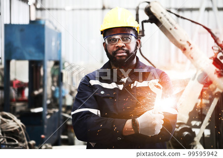 engineer teaching robot welding machine , he explanation how to working of robot arm , all function is controlled by remote engineer teaching robot welding machine , he explanation how to working of robot arm , all function is controlled by remote 99595942