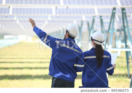 engineer working at solar farm 99596073
