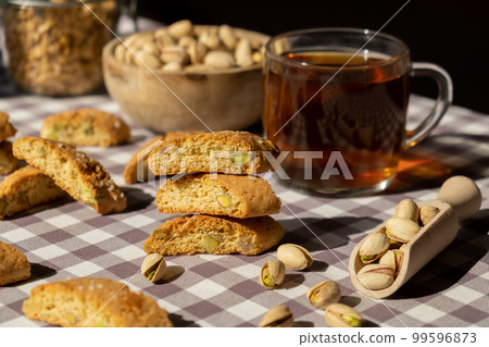 Biscotti Cantuccini Cookie Biscuits with pistachios and lemon peel Shortbread. Cup of tea. Teatime break Healthy eating food. Homemade fresh Italian cookies cantucci stacks and organic pistachios Biscotti Cantuccini Cookie Biscuits with pistachios and lemon peel Shortbread. Cup of tea. Teatime break Healthy eating food. Homemade fresh Italian cookies cantucci stacks and organic pistachios 99596873