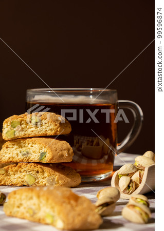 Biscotti Cantuccini Cookie Biscuits with pistachios and lemon peel Shortbread. Cup of tea. Teatime break Healthy eating food. Homemade fresh Italian cookies cantucci stacks and organic pistachios Biscotti Cantuccini Cookie Biscuits with pistachios and lemon peel Shortbread. Cup of tea. Teatime break Healthy eating food. Homemade fresh Italian cookies cantucci stacks and organic pistachios 99596874