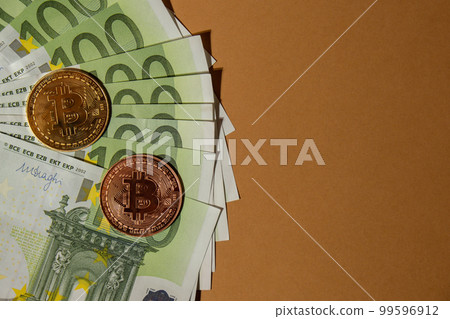 Bitcoin gold coin on bills of 100 euros eu currency. Bitcoin mining trading concept. BTC golden money spinning around. Worldwide virtual internet Cryptocurrency or crypto digital payment system Bitcoin gold coin on bills of 100 euros eu currency. Bitcoin mining trading concept. BTC golden money spinning around. Worldwide virtual internet Cryptocurrency or crypto digital payment system 99596912
