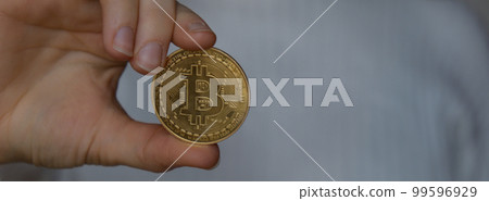 Female hands holding Bitcoin gold coin. Banner Bitcoin mining trading concept. BTC golden money spinning around. Worldwide virtual internet Cryptocurrency or crypto digital payment system Female hands holding Bitcoin gold coin. Banner Bitcoin mining trading concept. BTC golden money spinning around. Worldwide virtual internet Cryptocurrency or crypto digital payment system 99596929