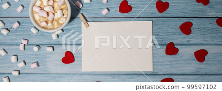 Banner Greeting or invitation card mock up with red hearts with white cup of coffee and marshmallows on wooden background. Romantic Valentine day. Blank paper card copy space for your text. Holiday Banner Greeting or invitation card mock up with red hearts with white cup of coffee and marshmallows on wooden background. Romantic Valentine day. Blank paper card copy space for your text. Holiday 99597102