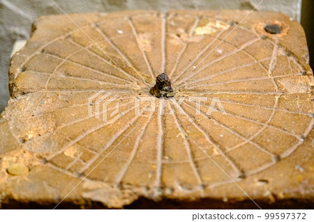 Sun clock. Very old 13th century sundial exhibit of the Turaida Castle Museum. Latvia 99597372