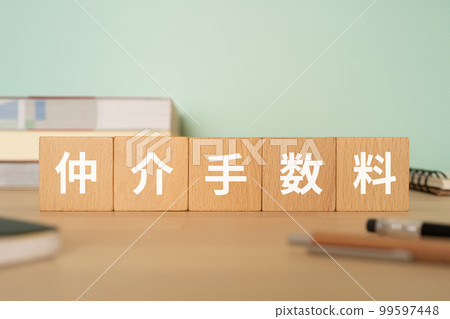 A desk with a block labeled Brokerage Fee 99597448