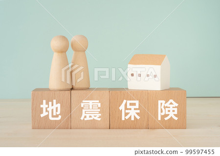A block written as earthquake insurance, a doll and a block 99597455