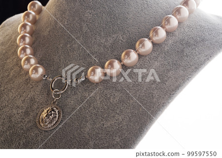 author beautiful  soft pink pearls necklaces demonstrated on maneken. fashion and jewelry concept author beautiful  soft pink pearls necklaces demonstrated on maneken. fashion and jewelry concept 99597550
