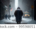 Man in the city walking at snow storm 99598051