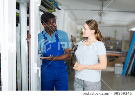 Male master is talking with female client about modern windows Male master is talking with female client about modern windows 99599346