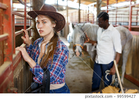 Woman who works at stable Woman who works at stable 99599427