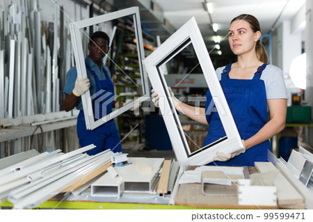 Portrait of woman worker who is standing with window frame 99599471