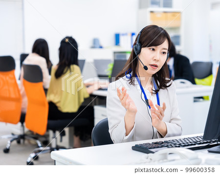Woman having a remote meeting in the office Woman having a remote meeting in the office 99600358