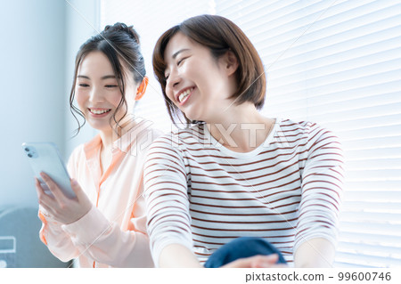 Two women using smartphones Two women using smartphones 99600746