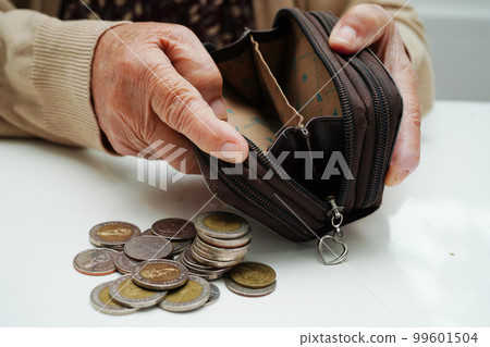 Retired elderly woman counting coins money and worry about monthly expenses and treatment fee payment. Retired elderly woman counting coins money and worry about monthly expenses and treatment fee payment. 99601504