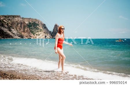 Pretty young blonde woman walking on the beach in summer, having fun, walks carefree on the seaside . Portrait beautiful young woman relax smile around beach sea ocean in holiday vacation travel trip Pretty young blonde woman walking on the beach in summer, having fun, walks carefree on the seaside . Portrait beautiful young woman relax smile around beach sea ocean in holiday vacation travel trip 99605014