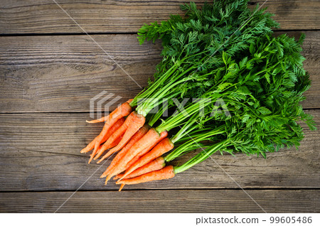 carrot on wooden table background, Fresh and sweet carrots for cooking food fruits and vegetables for health concept, baby carrots bunch and leaf carrot on wooden table background, Fresh and sweet carrots for cooking food fruits and vegetables for health concept, baby carrots bunch and leaf 99605486