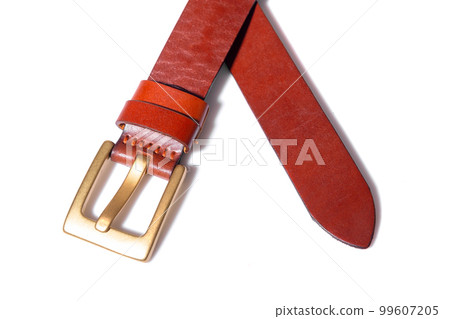 A crossed brown leather belt with a metal buckle on a white background is isolated. 99607205