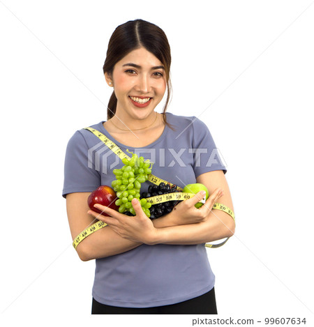 Young asian woman in fitness clothes holding fruits with  measuring tape. Portrait on white background with studio light. Healthy nutrition and weight losing concept. 99607634