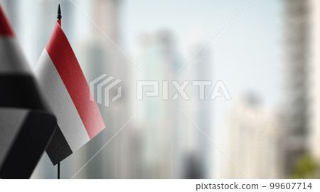 Small flags of the Yemen on an abstract blurry background 99607714