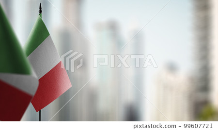 Small flags of the Italy on an abstract blurry background 99607721