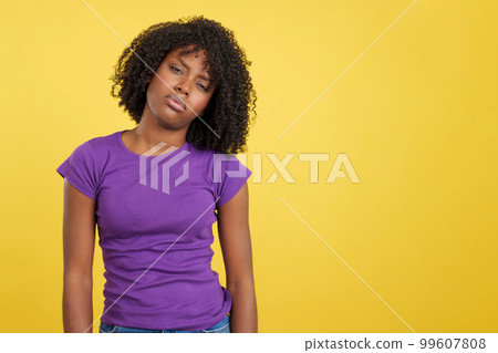 Woman with African hair standing in discomfort 99607808