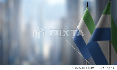 Small flags of the Sierra Leone on an abstract blurry background 99607874