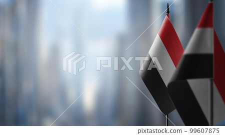Small flags of the Yemen on an abstract blurry background 99607875