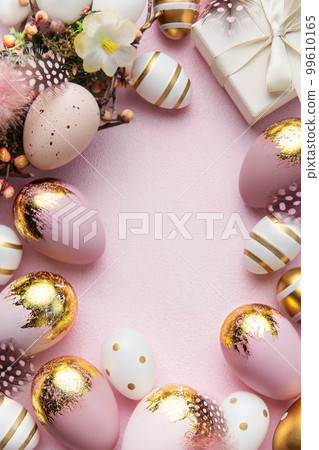 Easter golden eggs, gift box and decorations on pink  background. 99610165