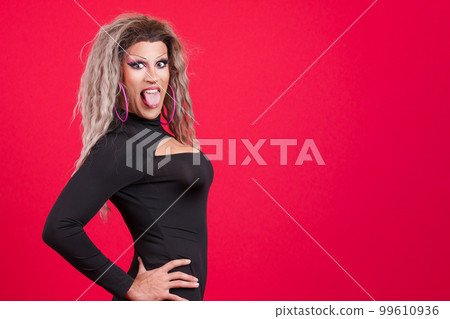 Playful transgender person sticking out his tongue 99610936