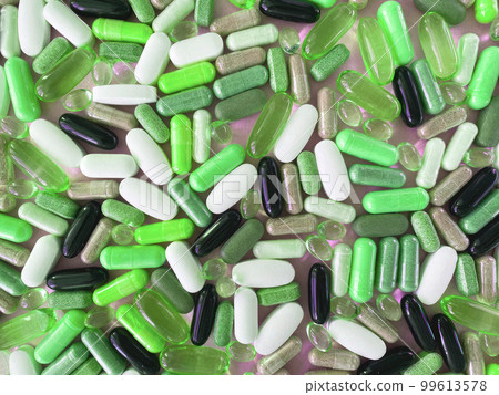 A backdrop of green brightly colored pills and pads 99613578