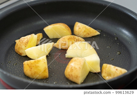 Fry potatoes in a frying pan Fry potatoes in a frying pan 99613629