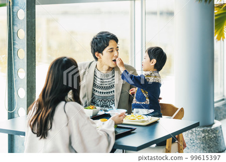 family eating out at a restaurant 99615397