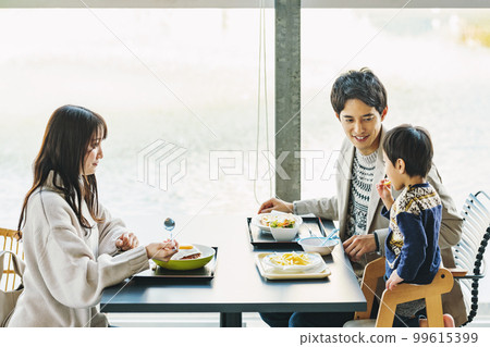 family eating out at a restaurant 99615399