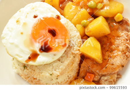fried rice garlic and butter with pork steak dressing potato curry sauce topping egg on plate fried rice garlic and butter with pork steak dressing potato curry sauce topping egg on plate 99615593