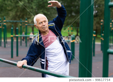 Senior man doing warming up exercises 99617754