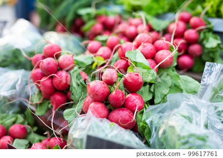 bunches of fresh radishes on store counter 99617761