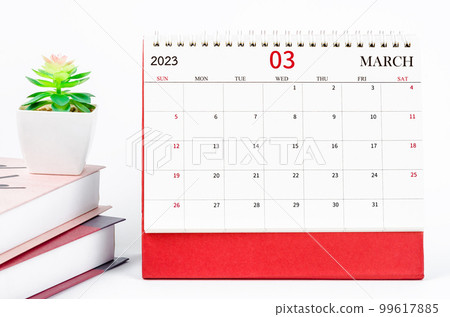 The March 2023 Monthly desk calendar for 2023 year with books on white background. 99617885