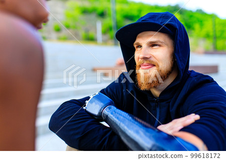 man with arm prosthesis in sports clothing ready for morning workout outdoors. Disabled sport concept 99618172