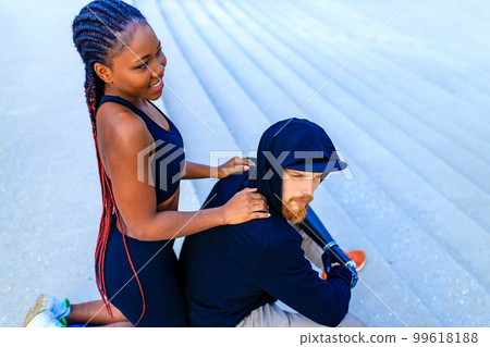 spain woman with afro pigtails crossfit trainer motivating her boyfriend for morning running outdoors in sity spain woman with afro pigtails crossfit trainer motivating her boyfriend for morning running outdoors in sity 99618188
