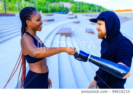 spain woman with afro pigtails crossfit trainer motivating her boyfriend for morning running outdoors in sity spain woman with afro pigtails crossfit trainer motivating her boyfriend for morning running outdoors in sity 99618210