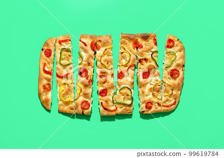 Homemade focaccia isolated on a green background Homemade focaccia isolated on a green background 99619784