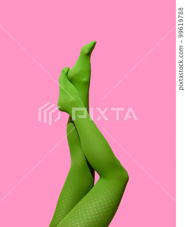 Woman legs in green tights isolated on a pink background Woman legs in green tights isolated on a pink background 99619788