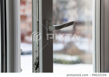 Open white plastic pvc window in winter on a cloudy day. 99620109