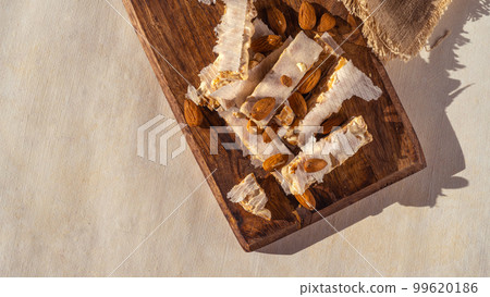 Almond turron dessert slices on wooden desk 99620186