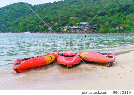 sea kayaks or multicolor boat on beautiful beach in Thailand 99620319