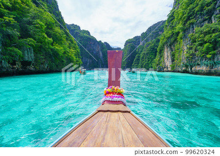Traveling with long tail boat on fantastic emerald lagoon sea at Koh Phi Phi Island Thailand, Pileh Lagoon. 99620324